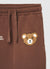 Pantaloni ginnici over con coulisse e patch orso