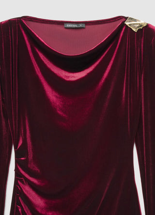 Short dress with draping and brooch