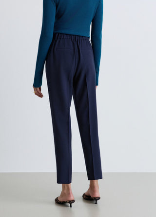Trousers with pleats and elasticated waistband